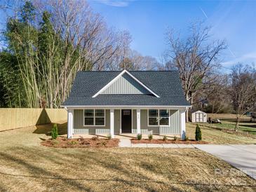 Charming single-story home with a well-manicured lawn and inviting front porch at 119 E Ohio Ave, Bessemer City, NC 28016