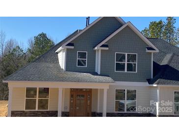 Charming home featuring a stone foundation, wood-look siding, and a classic roofline at 217 Heartland Dr, Rock Hill, SC 29732