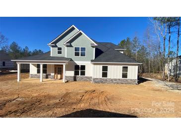 Newly constructed two-story home with gray and white siding and a covered front porch at 217 Heartland Dr, Rock Hill, SC 29732