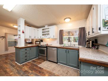 Modern kitchen features stainless steel appliances and updated cabinetry at 3401 Stony Brook Cir, Newton, NC 28658