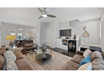 Inviting living room with dark wood floors, plush seating, stylish decor, and convenient wine storage at 1909 Wilmore Walk Dr # 44, Charlotte, NC 28203