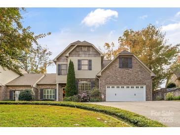 Two-story brick home with a large driveway and landscaping at 119 42Nd Avenue Nw Dr, Hickory, NC 28601