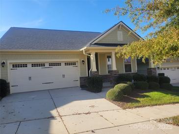 Charming single-Gathering home showcasing a well-maintained lawn, two-car garage, and inviting front porch at 129 Johnson Manor St, Mooresville, NC 28115
