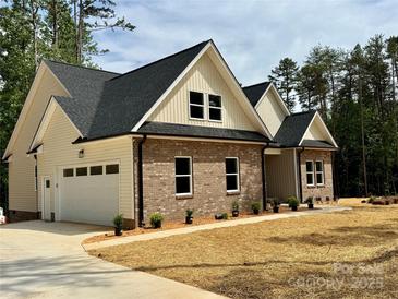 Beautiful brick home featuring a two-car garage, complemented by manicured landscaping at 315 Bonaventure Dr, Salisbury, NC 28147