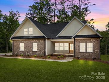 Charming brick home featuring a well-manicured lawn and inviting front porch at 315 Bonaventure Dr, Salisbury, NC 28147