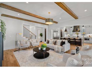 Open living room showcasing hardwood floors, a stylish neutral color palette, and an open concept design at 705 Mcalway Rd, Charlotte, NC 28211