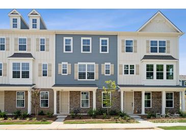 Two-story townhouses with gray siding, stone accents, and landscaping at 7109 Brookview Ln, Sherrills Ford, NC 28673