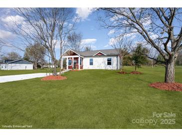 Newly built home with red and white siding, a covered porch and a landscaped yard at 1244 Bob Falls Rd, Shelby, NC 28150