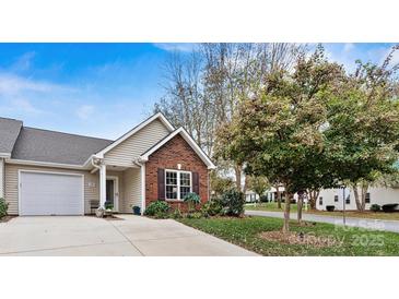 Brick front exterior of charming home with landscaping and driveway at 191 Oak Village Pkwy, Mooresville, NC 28117