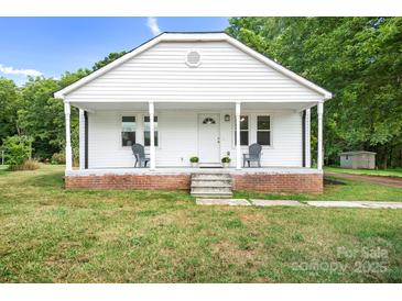 Charming white home with a cozy front porch and inviting curb appeal at 2401 Boy Scout Rd, Lincolnton, NC 28092