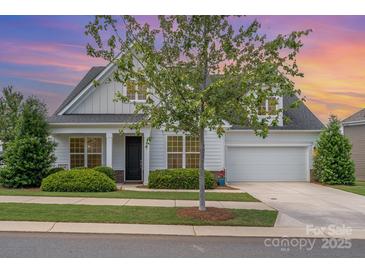 Charming two-story home featuring manicured lawn, a two-car garage and inviting front porch at 3029 Quinebaug Rd, Fort Mill, SC 29715