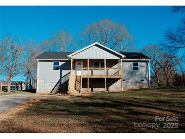 Newly constructed home with a gray exterior, front porch, and steps leading to the entrance at 201 School St, High Shoals, NC 28077