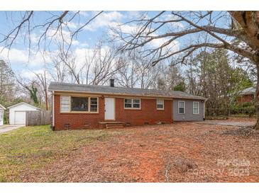 Charming single-story brick home with a white door and mature trees in the front yard at 2209 Dale Ave, Lincolnton, NC 28092