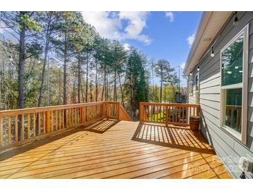 Inviting wooden deck perfect for entertaining with string lights and wooded view at 25622 Seagull Dr # 645, Lancaster, SC 29720