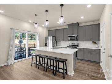 Modern kitchen with gray cabinets, white countertops, and island at 372 Olympia Way, York, SC 29745