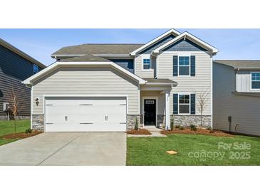 Charming two-story home with a two-car garage and manicured lawn at 550 Mountain View Dr, Monroe, NC 28110