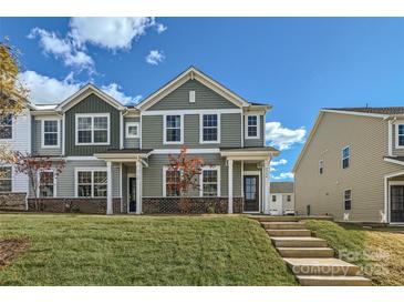 Modern two-story townhome with gray siding and a landscaped lawn at 9744 Inkberry Dr, Gastonia, NC 28056