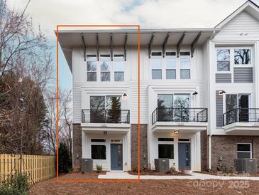 Charming townhome featuring a white exterior, balcony, and well-maintained landscaping at 1425 Collier Walk Aly # Csw0211, Charlotte, NC 28205