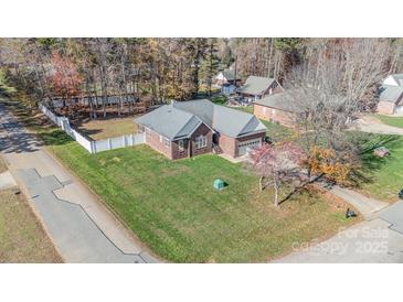 Brick ranch home with attached garage, situated on a landscaped lot at 1009 Amber Ct, China Grove, NC 28023