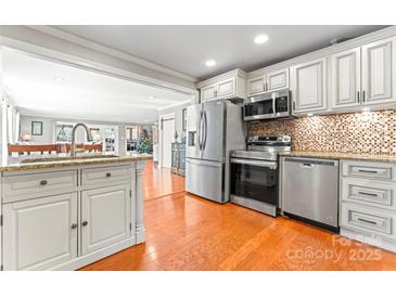 Modern kitchen features stainless steel appliances and granite countertops at 138 Wyanoke Ave, Charlotte, NC 28205