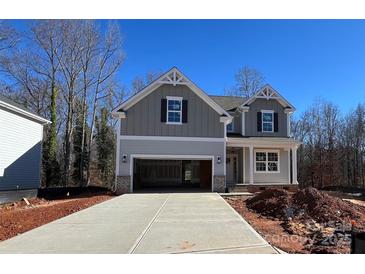 Two-story house with gray siding, a large driveway, and a partially landscaped yard at 2387 Trundle Dr # Cwo0155, Gastonia, NC 28054