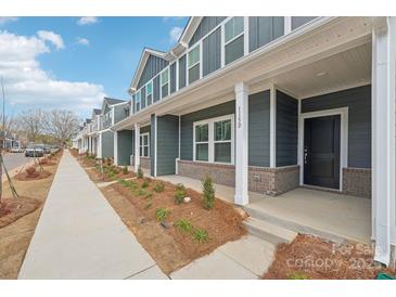 Gray townhome exterior with front porch and landscaping at 115 Ciara Pl # C, Mooresville, NC 28117