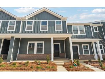 Gray two-story townhome with a front porch and landscaping at 115 Ciara Pl # D, Mooresville, NC 28117