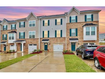 Modern three-story townhouses with attached garages and landscaped yards at 2608 Grantham Place Dr, Fort Mill, SC 29715