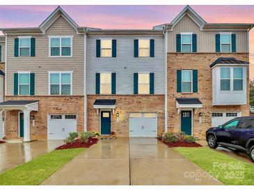 Three-story townhome with two-car garage and landscaped front yard at 2608 Grantham Place Dr, Fort Mill, SC 29715