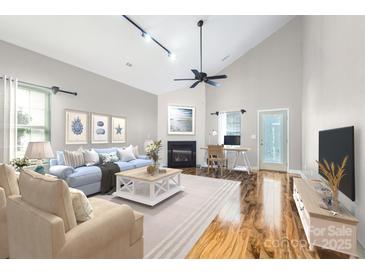 Bright and airy living room with vaulted ceilings and a cozy fireplace at 9311 Glenashley Dr, Cornelius, NC 28031