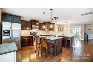 Modern kitchen with dark cabinets, stainless steel appliances, and island at 1964 Clear Brooke Dr, Kannapolis, NC 28083