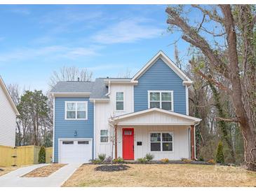 Two-story blue house with white accents, red door, and attached garage at 1000 Fairground St, Charlotte, NC 28208