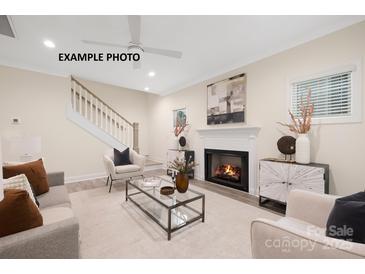 Bright living room features a fireplace and a view of the staircase at 1002 Fairground St, Charlotte, NC 28208