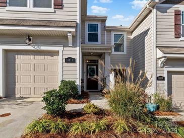 Exterior view of townhome with landscaping and two-car garage at 18014 Pear Hawthorne Dr, Huntersville, NC 28078