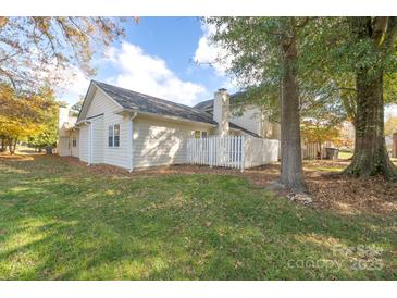 Charming home with a large backyard, mature trees, and white picket fence at 2702 New Hamlin Way, Charlotte, NC 28210