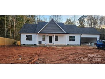 Charming one-story home featuring white siding, black roof, and a welcoming front porch at 536 Robinhood Rd # 27, Maiden, NC 28650