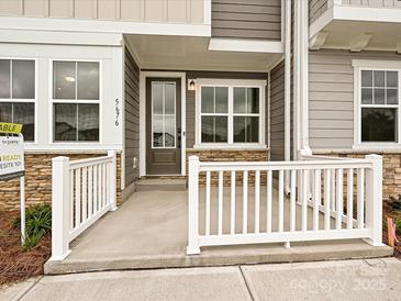Inviting front porch with stone accents and a white railing creates curb appeal at 5676 Clear Creek Ln, Charlotte, NC 28215
