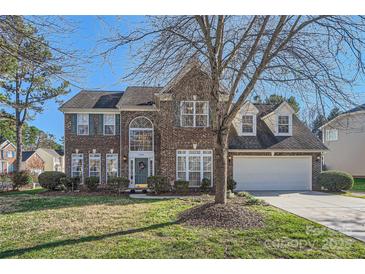 Brick two-story house with a large front yard and attached garage at 2240 Dunnwood Hills Dr, Matthews, NC 28105