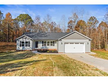 Charming single-story home with a two-car garage and a well-manicured lawn, all under a clear, sunny sky at 3146 Captains Cove Ln, Lincolnton, NC 28092
