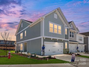 Charming two-story home featuring a two-car garage, craftsman details, and a beautifully landscaped front yard at 145 Halite Way, Waxhaw, NC 28173