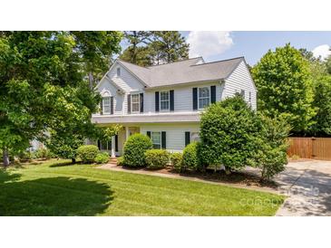 Charming two-story home with well-manicured lawn, mature trees, and classic shutters at 107 Monterey Dr, Mooresville, NC 28117