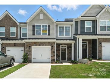 Charming townhome with stone accents, a one car garage, and craftsman style architecture at 6259 Tea Olive Dr # 178, Harrisburg, NC 28075