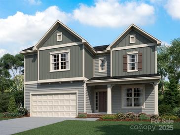 Two-story house with gray siding, white trim, and a two-car garage at 1029 Wandsworth Pl # Ken0105, Charlotte, NC 28215
