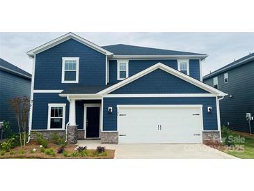 Charming two-story home with a blue exterior, white trim, stone accents, and a two-car garage at 106 Obadiah Ct, Troutman, NC 28115