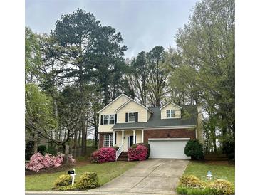 Charming two-story home boasts a brick-and-siding facade, manicured lawn, and flowering shrubs at 3195 Hadden Hall Blvd, Fort Mill, SC 29715