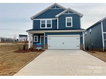 Two-story house with blue siding, white garage door, and landscaping at 103 Obadiah Ct, Mooresville, NC 28115