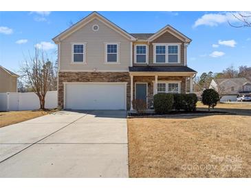 Charming two-story home featuring stone accents, a two-car garage, and a well-maintained front yard at 8007 April Ln, Matthews, NC 28104