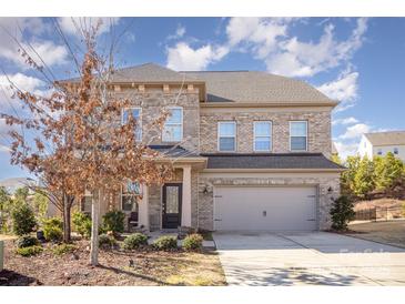 Two-story brick home with attached garage and landscaped front yard at 17712 Yarwill Ct, Charlotte, NC 28278