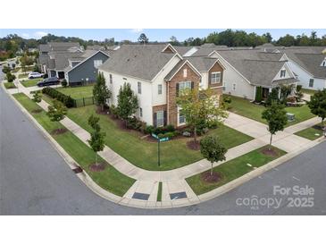 Attractive corner lot home with manicured lawn, tasteful landscaping and a combination of siding and stone facade at 13929 Tilesford Ln, Huntersville, NC 28078