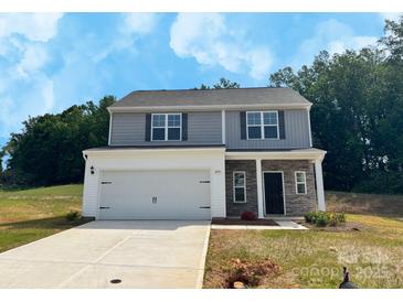 Charming two-story home featuring a two-car garage and stone accents at 204 Lake George Dr, Shelby, NC 28152